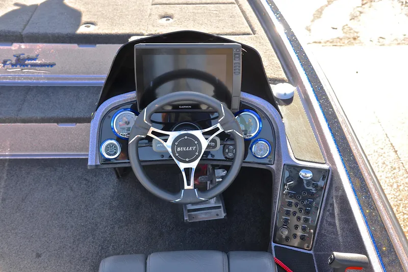 Slide: The Image of 2023 Bullet 21XRS boat dashboard with Garmin display and steering wheel. - 25
