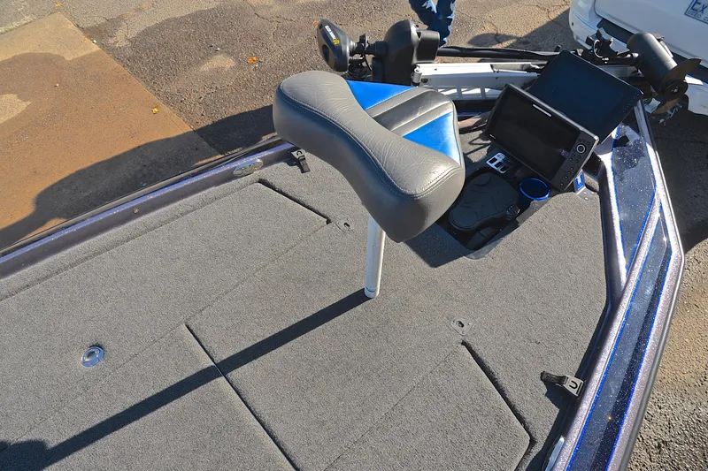 Slide: The Image of 2023 Bullet 21XRS boat deck with seat, control panel, and carpeted surface. - 26