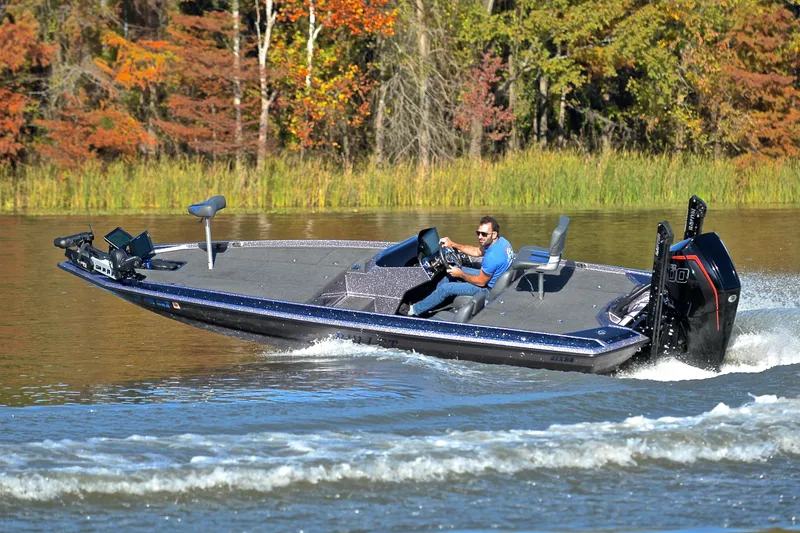 Slide: The Image of 2023 Bullet 21XRS boat cruising on a lake with autumn foliage in the background. - 6