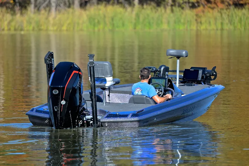 Slide: The Image of 2023 Bullet 21XRS boat on calm water, featuring advanced navigation equipment. - 8
