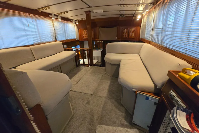 Slide: The Image of Interior of a 1980 Jersey 40FT Convertible yacht with beige seating and wooden accents. - 1
