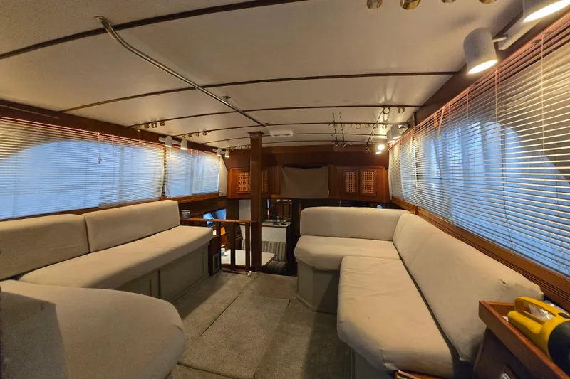 Slide: The Image of Interior of 1980 Jersey 40FT Convertible yacht with cozy seating and ambient lighting. - 11