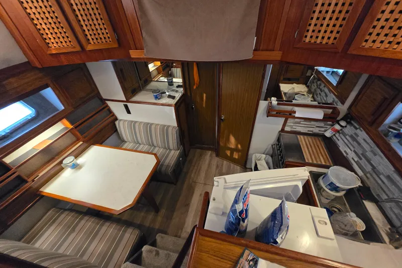 Slide: The Image of Interior of a 1980 Jersey 40FT Convertible boat with cozy seating and kitchen area. - 2