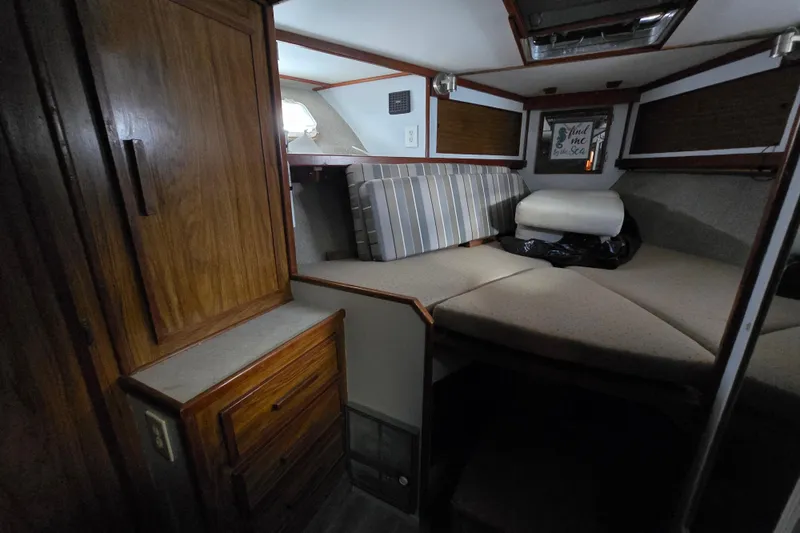 Slide: The Image of Cozy cabin interior of a 1980 Jersey 40FT Convertible boat with wood cabinetry. - 20