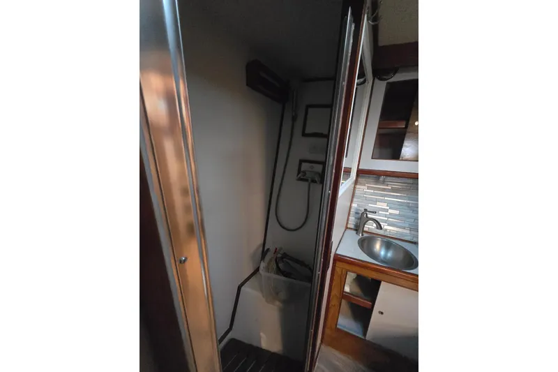 Slide: The Image of 1980 Jersey 40FT Convertible yacht interior with shower and sink area. - 22