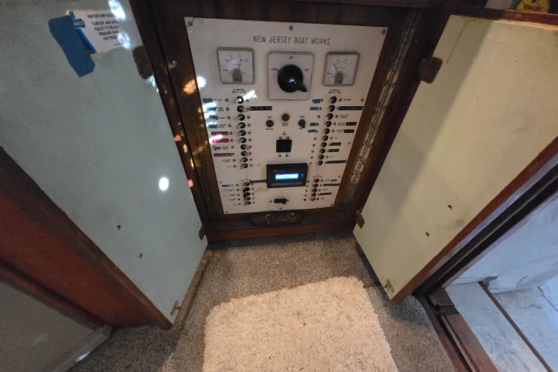 Slide: The Image of Electrical panel of a 1980 Jersey 40FT Convertible boat, featuring gauges and switches. - 26