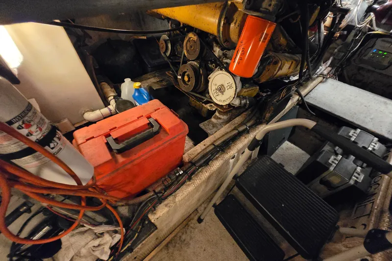 Slide: The Image of Engine room of a 1980 Jersey 40FT Convertible boat with tools and equipment. - 27