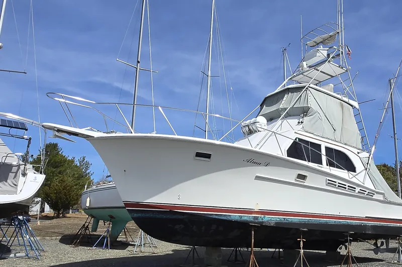 Slide: The Image of 1980 Jersey 40FT Convertible boat on stands, clear sky background. - 3
