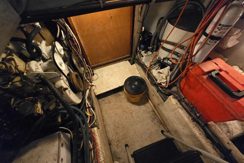 Slide: The Image of Engine room of a 1980 Jersey 40FT Convertible boat with visible wiring and equipment. - 30