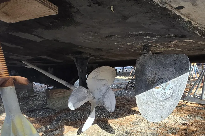 Slide: The Image of 1980 Jersey 40FT Convertible boat underside with propeller and rudder in dry dock. - 31