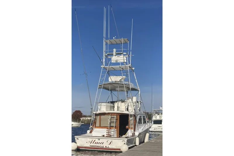 Slide: The Image of 1980 Jersey 40FT Convertible boat docked under clear blue sky. - 35