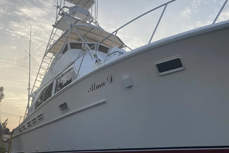 Slide: The Image of 1980 Jersey 40FT Convertible boat, named Alma D, viewed from below against sky. - 37