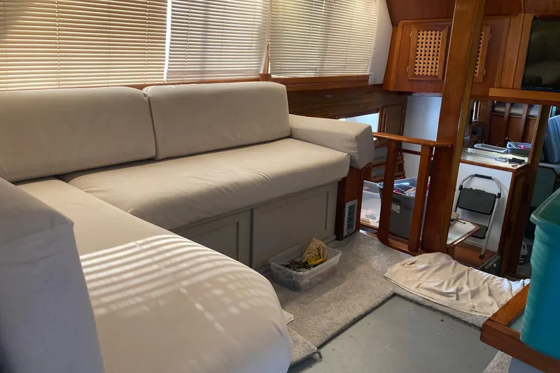 Slide: The Image of Interior of 1980 Jersey 40FT Convertible yacht with white sofa and wooden accents. - 41