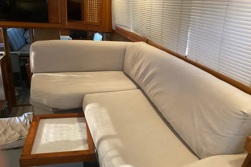 Slide: The Image of Interior of 1980 Jersey 40FT Convertible with beige sofa and wooden accents. - 42