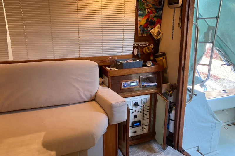 Slide: The Image of Interior of a 1980 Jersey 40FT Convertible boat with beige seating and control panel. - 43