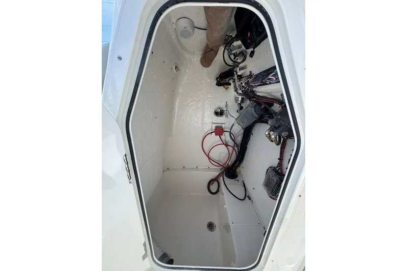 Slide: The Image of Interior view of 2026 Key West 203 FS boat compartment with wiring and components. - 14