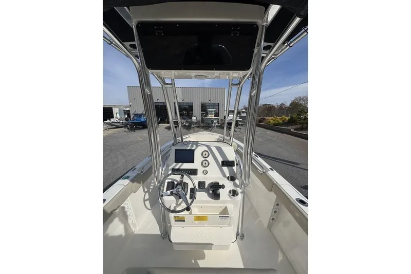 Slide: The Image of 2026 Key West 203 FS boat dashboard with steering wheel and controls. - 15