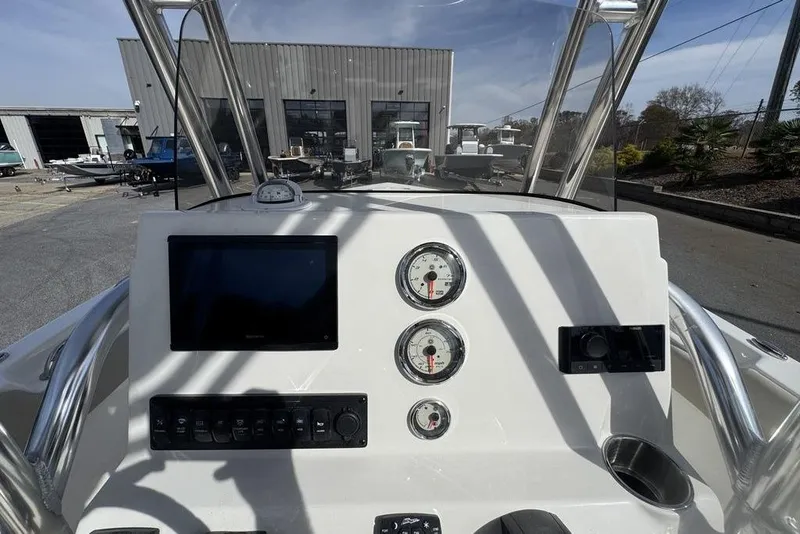 Slide: The Image of 2026 Key West 203 FS boat dashboard with gauges and navigation screen. - 17