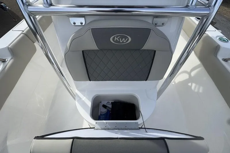 Slide: The Image of 2026 Key West 203 FS boat interior with storage compartment and cushioned seating. - 19