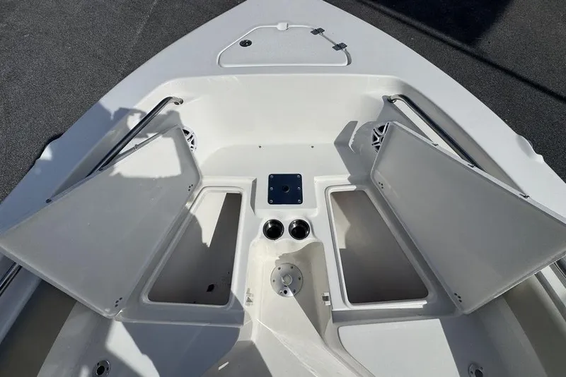 Slide: The Image of 2026 Key West 203 FS boat interior with open storage compartments and cup holders. - 20