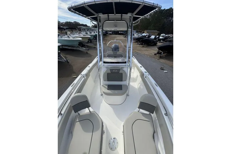 Slide: The Image of 2026 Key West 203 FS boat with seating and canopy, displayed in a marina setting. - 24