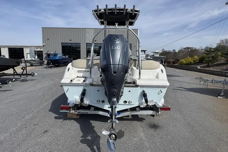 Slide: The Image of 2026 Key West 203 FS boat with Yamaha 150 engine, parked outdoors. - 6