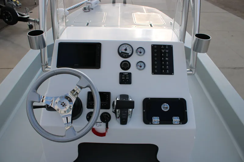 Slide: The Image of 2026 Mamba 24 Cat Elite boat dashboard with steering wheel and control panel. - 5