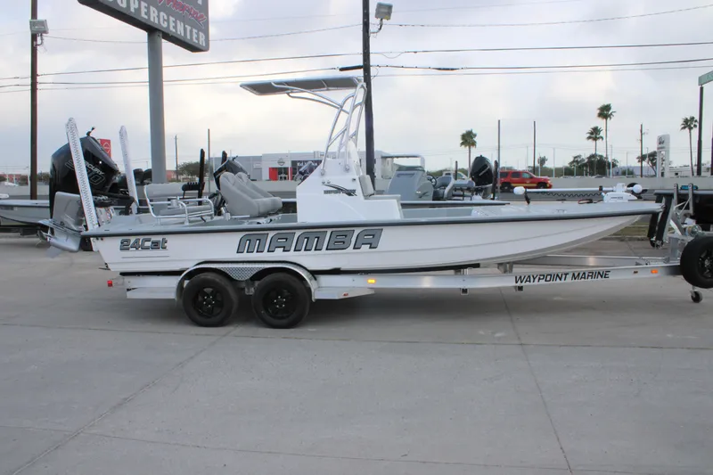 Slide: The Image of 2026 Mamba 24 Cat Elite boat on trailer at dealership, side view. - 7
