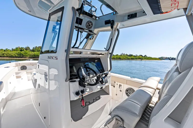 Slide: The Image of 2025 Solace 32 CS boat interior with wooden cabinetry, toilet, and sink. - 13