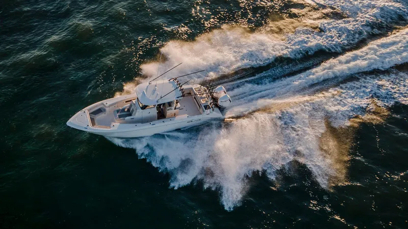 Slide: The Image of 2025 Solace 32 CS boat interior with seating and storage, cruising on a sunny day. - 2