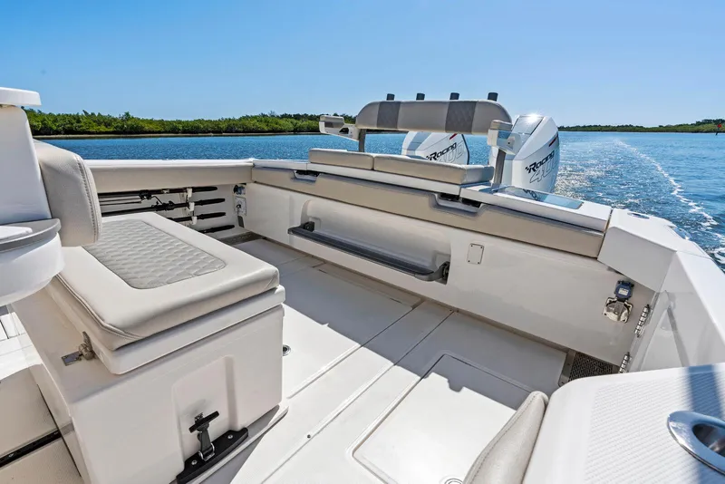 Slide: The Image of 2025 Solace 32 CS boat interior with modern helm, steering wheel, and seating, on a sunny day. - 8