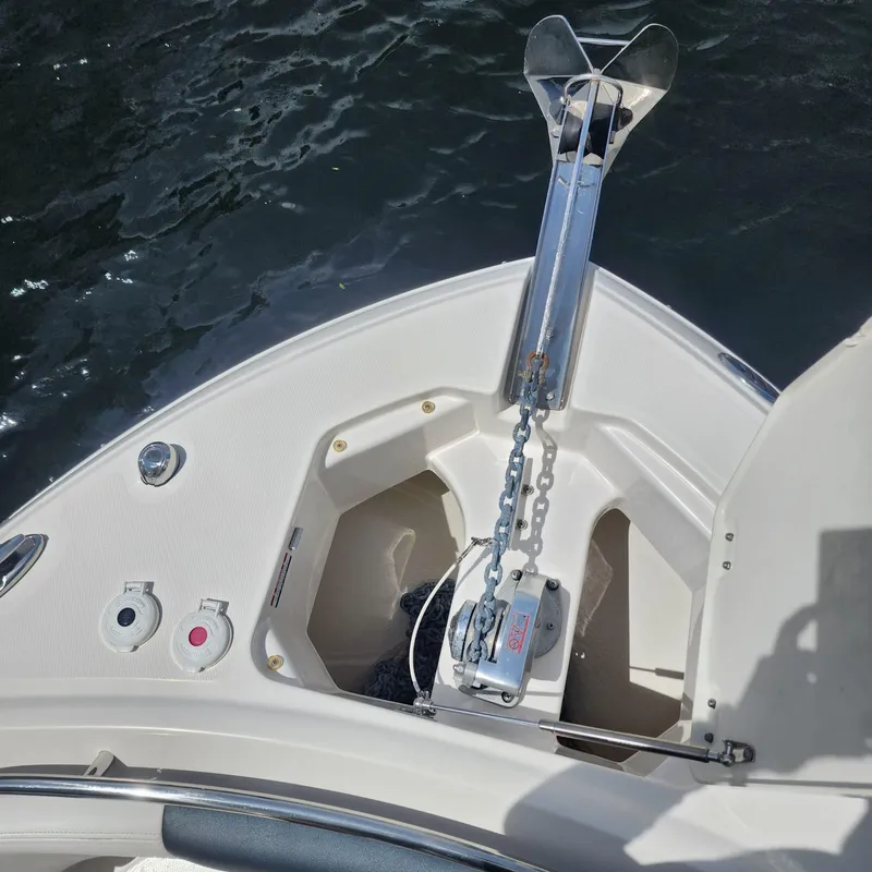 Slide: The Image of 2021 Robalo R247 Dual Console boat anchor system on water. - 10
