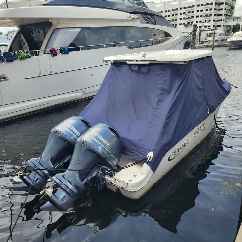 Slide: The Image of 2021 Robalo R247 Dual Console boat with Yamaha engines, docked and covered. - 12
