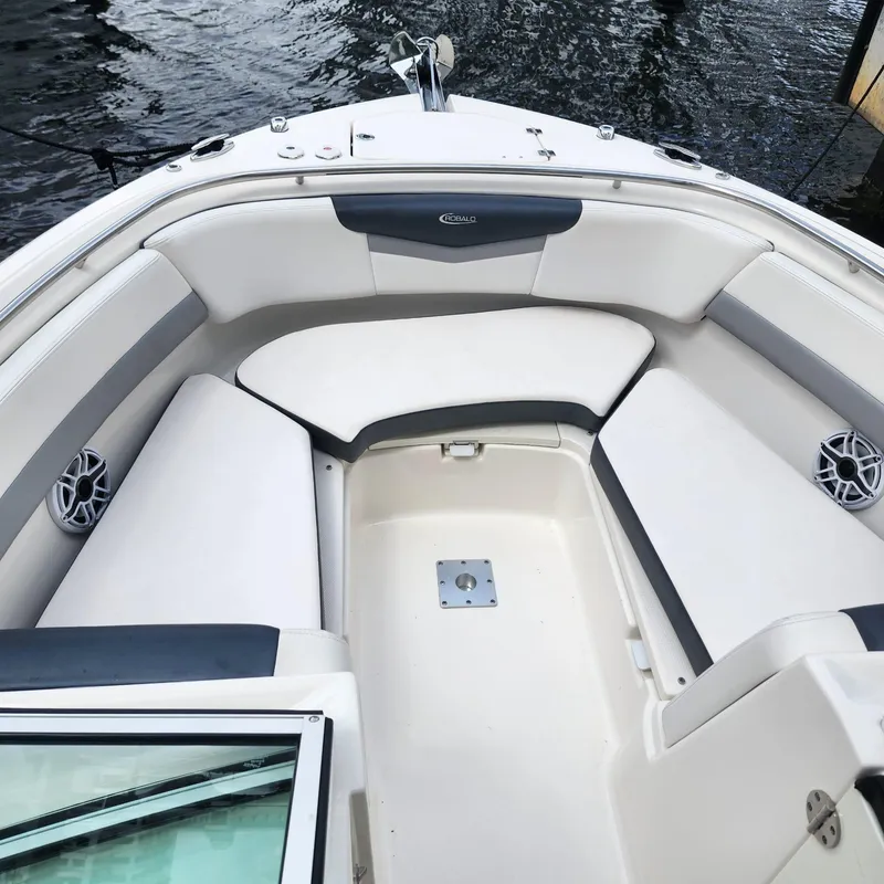 Slide: The Image of 2021 Robalo R247 Dual Console boat interior with white seating and open bow design. - 8