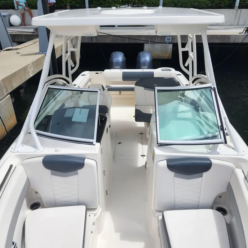 Slide: The Image of 2021 Robalo R247 Dual Console boat with open seating and twin engines. - 9