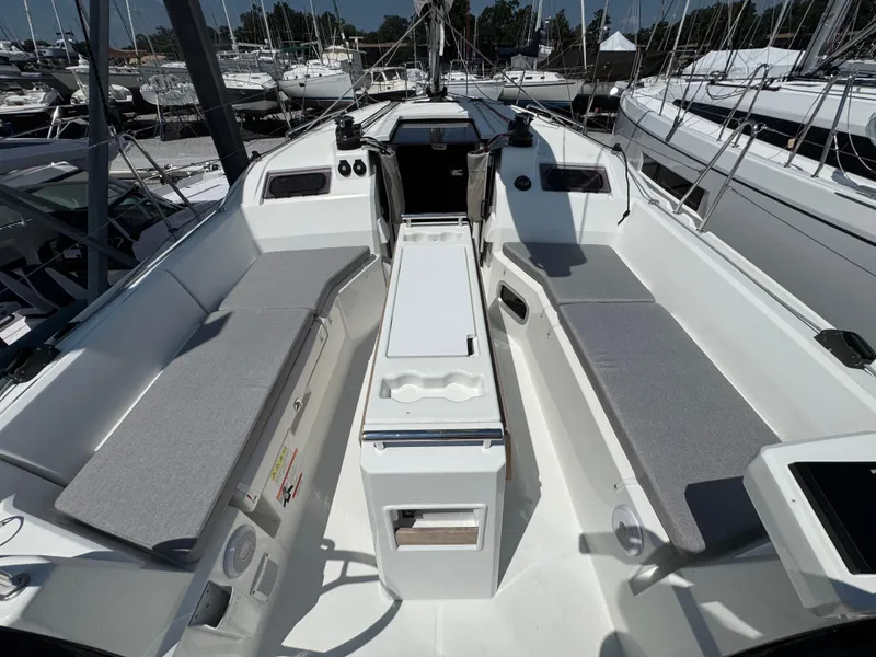 Slide: The Image of 2024 Beneteau Oceanis 34.1 sailboat cockpit with seating and control panel, docked at marina. - 3