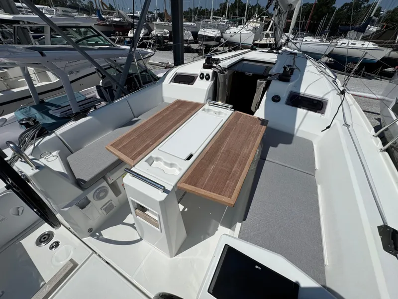 Slide: The Image of 2024 Beneteau Oceanis 34.1 yacht cockpit with wooden table and seating. - 7