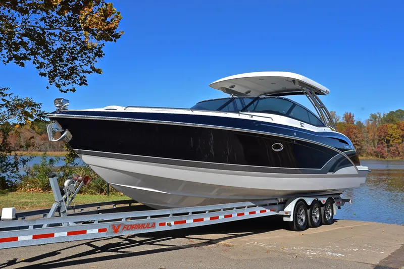 Slide: The Image of 2016 Formula 350 Crossover Bowrider on trailer by a scenic lake. - 10