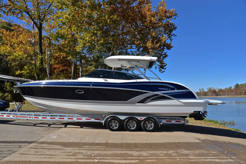 Slide: The Image of 2016 Formula 350 Crossover Bowrider on trailer by a scenic lake. - 11