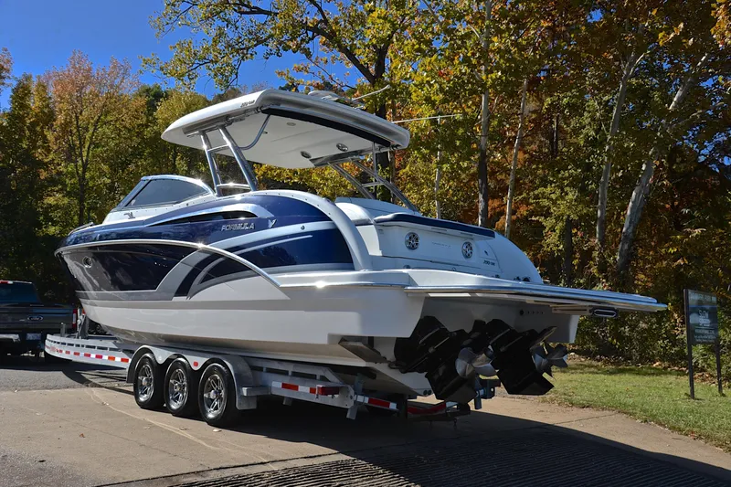 Slide: The Image of 2016 Formula 350 Crossover Bowrider on trailer, surrounded by autumn trees. - 12