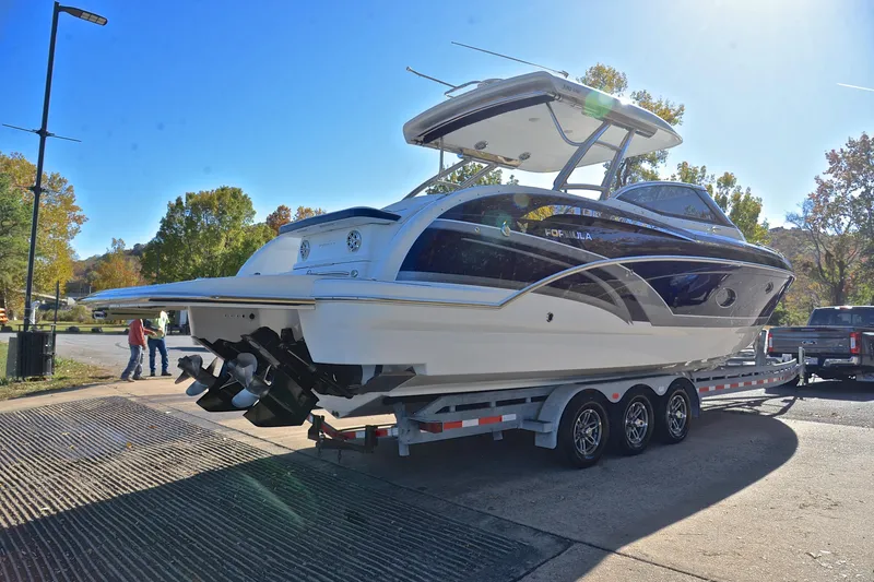 Slide: The Image of 2016 Formula 350 Crossover Bowrider on trailer, parked outdoors under clear sky. - 14