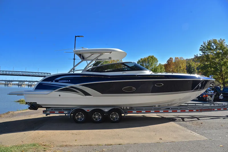 Slide: The Image of 2016 Formula 350 Crossover Bowrider on trailer by riverside, clear blue sky. - 15