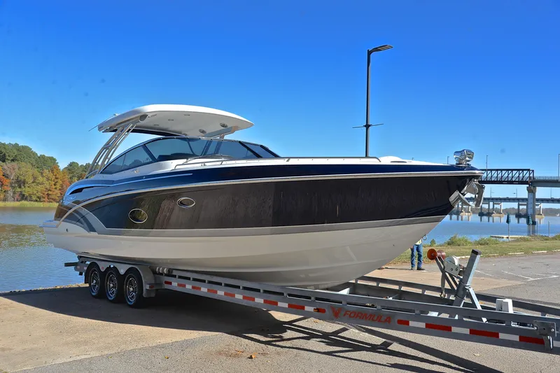 Slide: The Image of 2016 Formula 350 Crossover Bowrider on trailer by a scenic waterfront. - 16