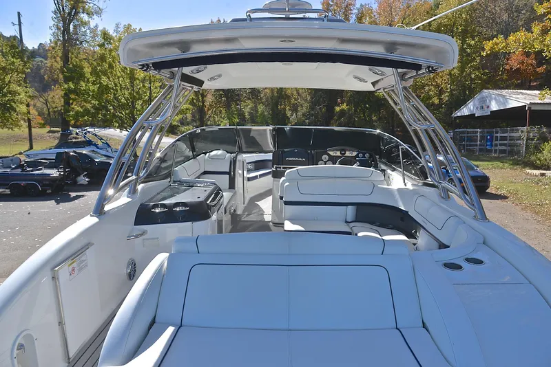 Slide: The Image of 2016 Formula 350 Crossover Bowrider with spacious seating and sleek design in a scenic setting. - 18