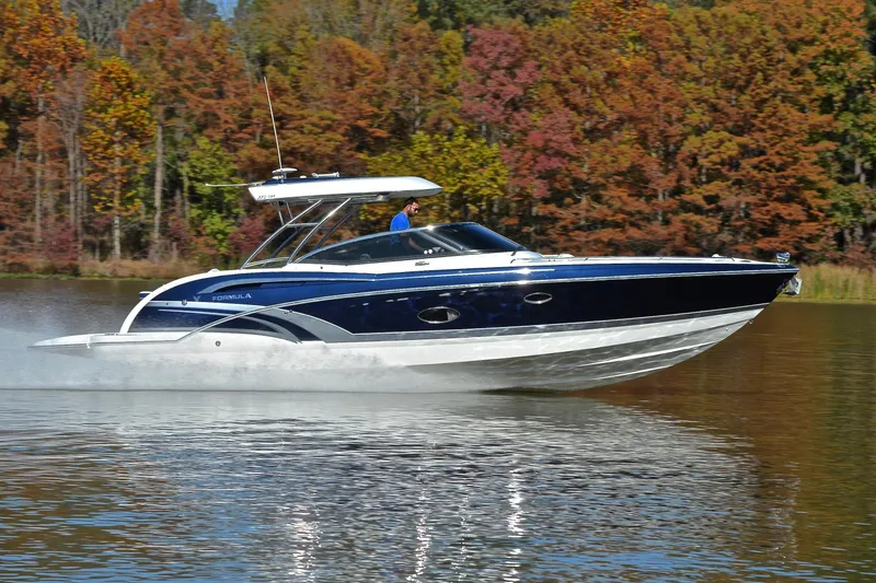 Slide: The Image of 2016 Formula 350 Crossover Bowrider cruising on a lake with autumn foliage backdrop. - 3