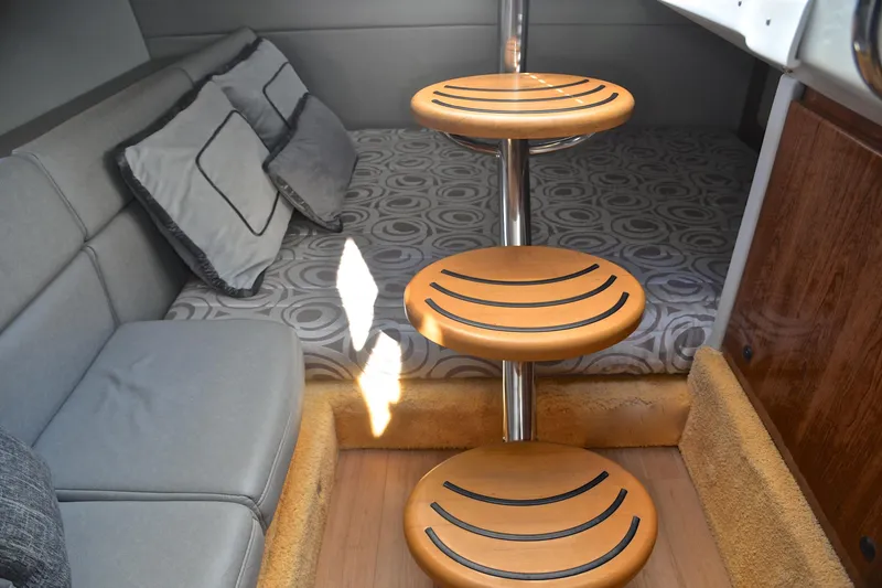 Slide: The Image of 2016 Formula 350 Crossover Bowrider cabin interior with wooden steps and cushioned seating. - 32