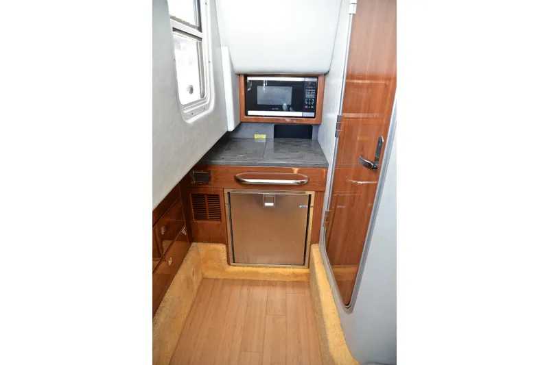 Slide: The Image of 2016 Formula 350 Crossover Bowrider interior with microwave and mini-fridge. - 44