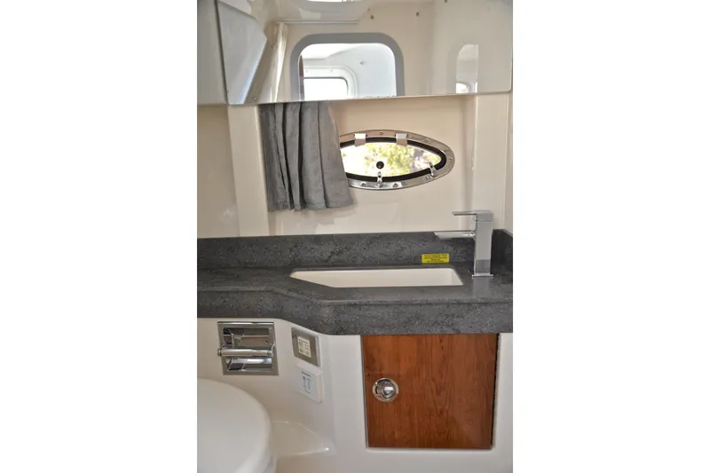 Slide: The Image of 2016 Formula 350 Crossover Bowrider bathroom with sink, mirror, and porthole window. - 46
