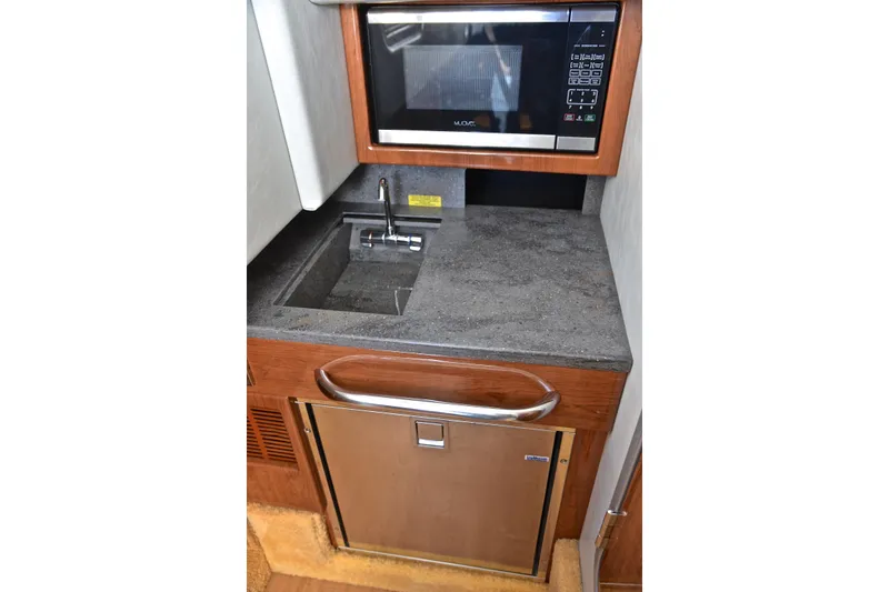 Slide: The Image of Compact kitchenette in 2016 Formula 350 Crossover Bowrider with microwave, sink, and mini-fridge. - 47