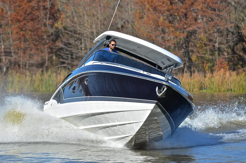 Slide: The Image of 2016 Formula 350 Crossover Bowrider cruising on a lake with autumn trees. - 50